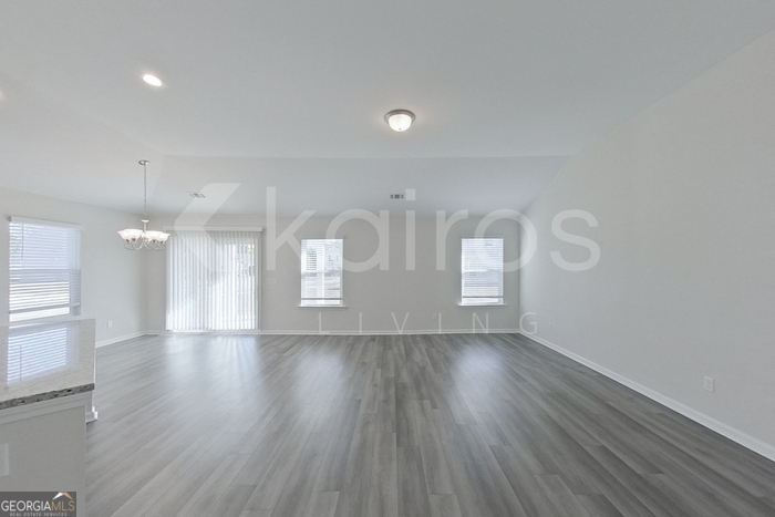 109 Bluff Road Springfield, GA 31329 - Photo 8 of 21 a view of an empty room with wooden floor and window
