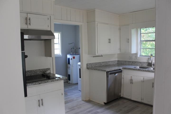 875 Woodrow Street Silsbee, TX 77656 - Photo 15 of 30 a kitchen with a sink stove and cabinets