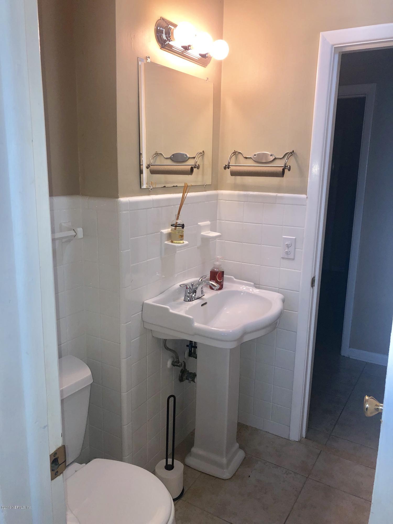 2422 Provost Road East Jacksonville, FL 32216 - Photo 13 of 18 a bathroom with a sink a toilet and a mirror