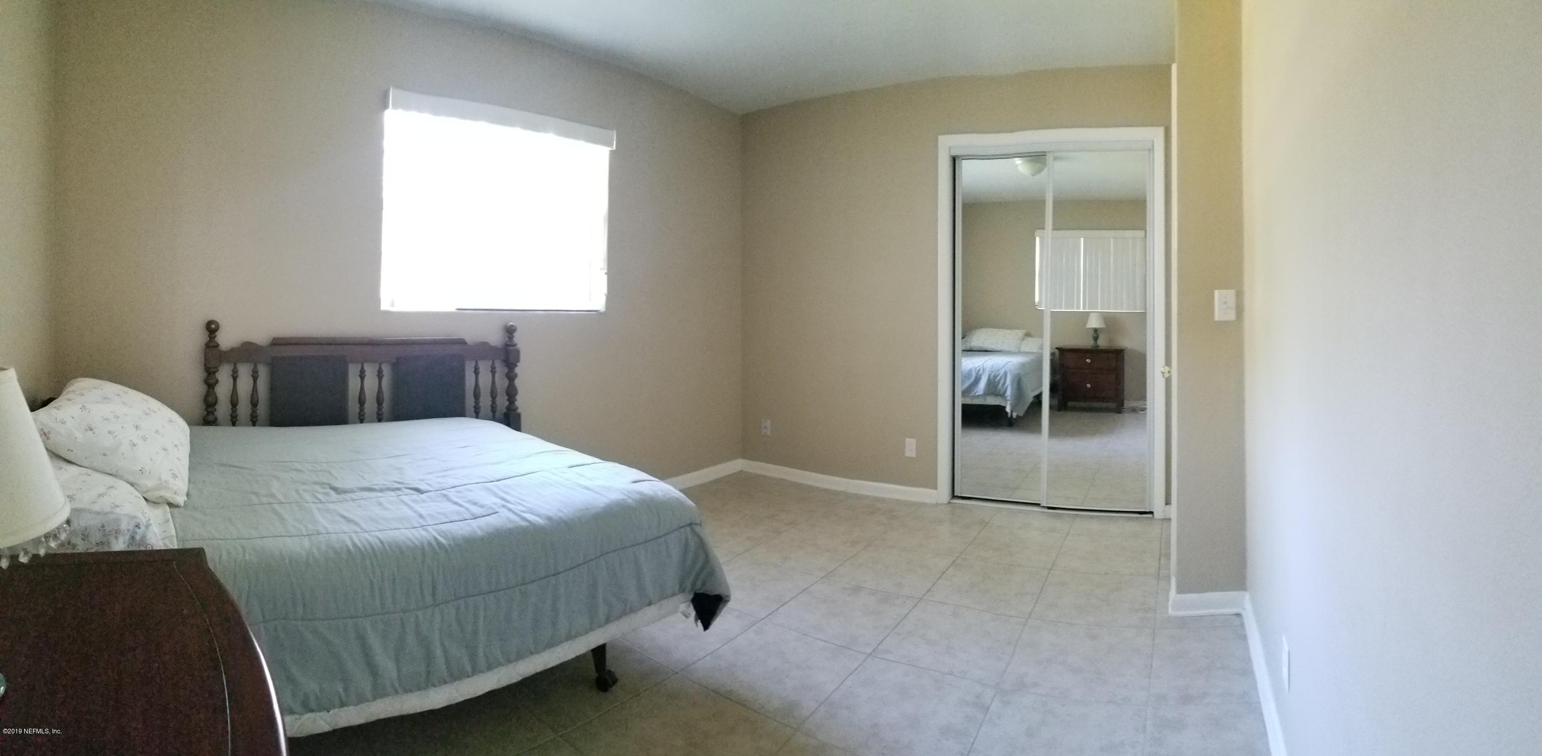 2422 Provost Road East Jacksonville, FL 32216 - Photo 14 of 18 a bedroom with a bed and a window