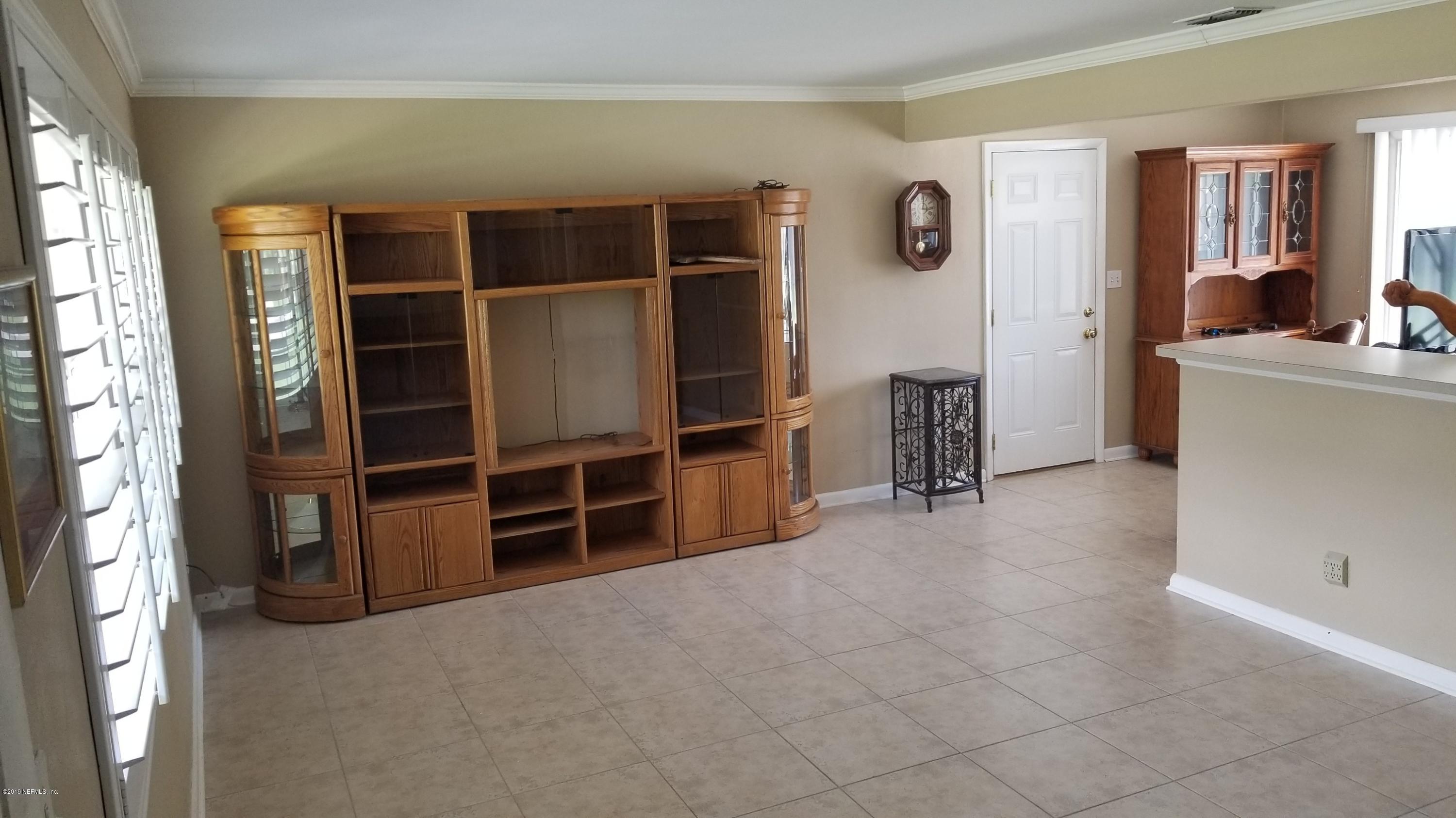 2422 Provost Road East Jacksonville, FL 32216 - Photo 4 of 18 a view of an empty room with shelves and a window