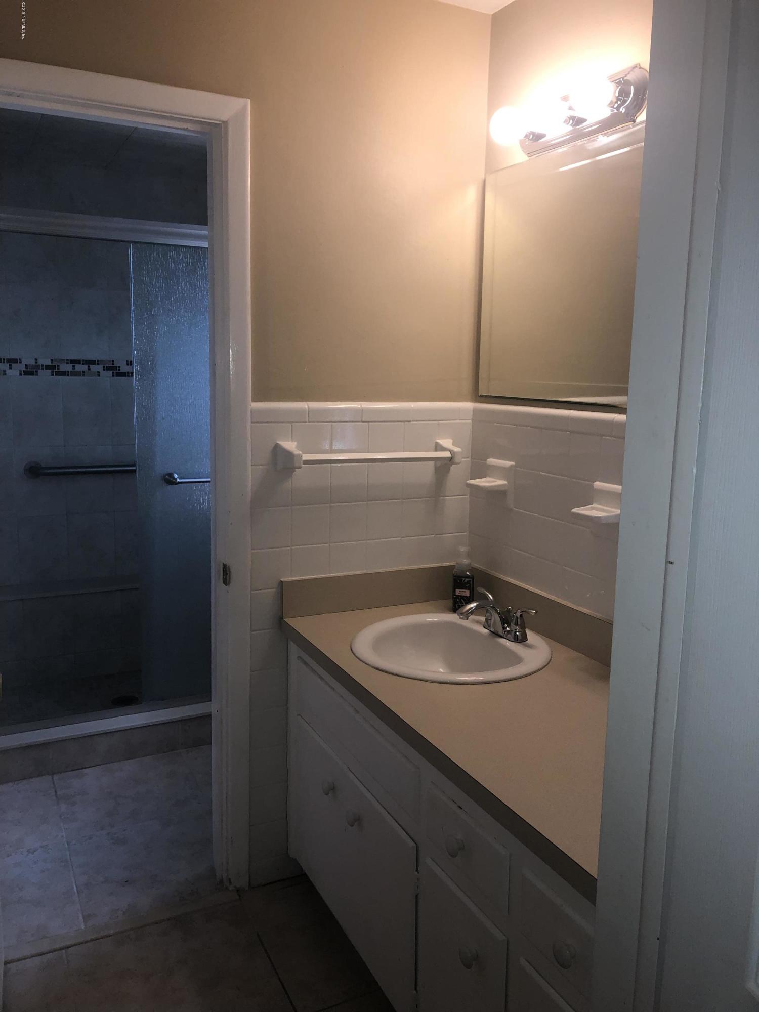 2422 Provost Road East Jacksonville, FL 32216 - Photo 10 of 18 a bathroom with a sink and a mirror