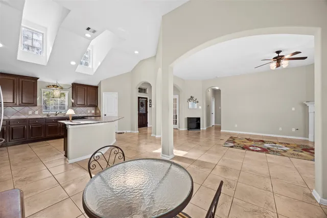 a very nice looking dining room with a couch and chandelier