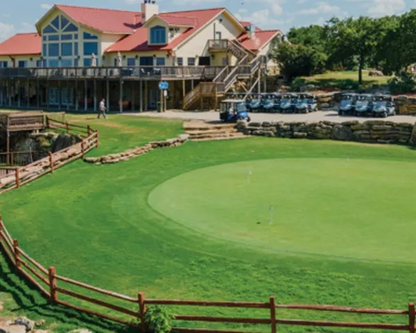 a view of a house with a big yard and sitting area