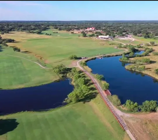 an aerial view of ocean residential houses with outdoor space and trees