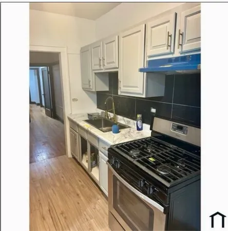 a kitchen with a stove and a white cabinet