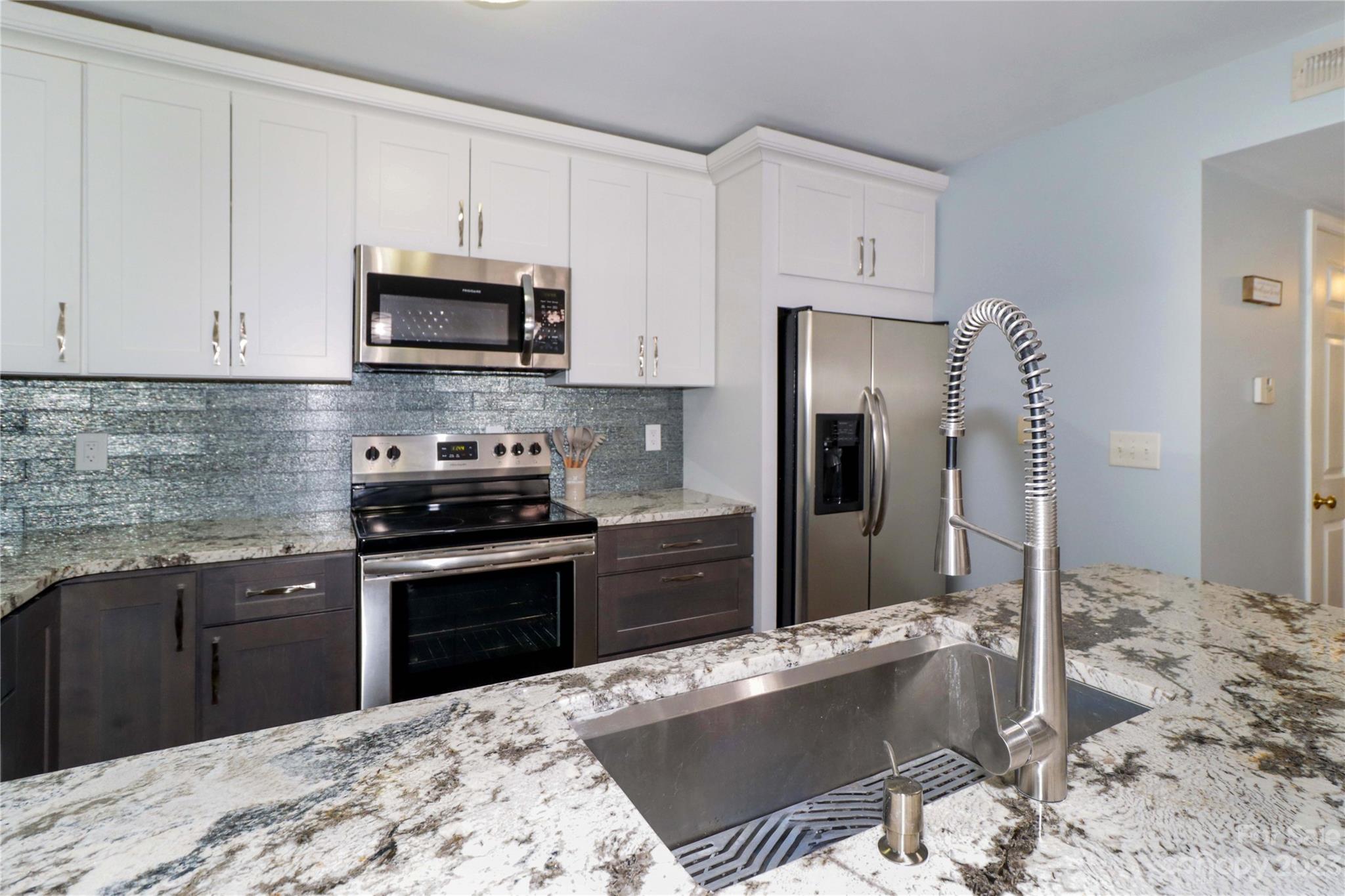 160 James Road, Unit 1D High Point, NC 27265 - Photo 13 of 33 a kitchen with granite countertop a stove sink and refrigerator