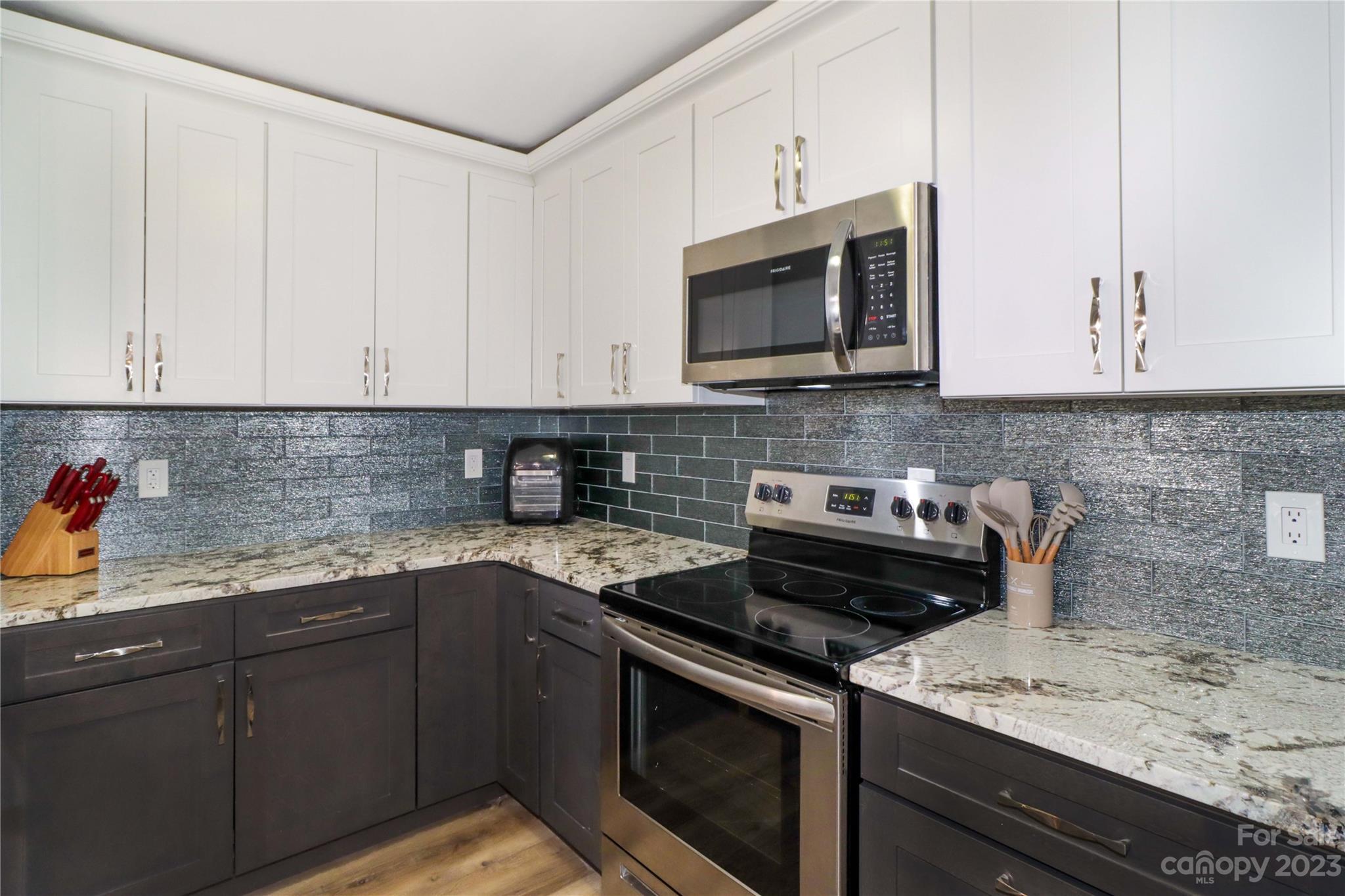 160 James Road, Unit 1D High Point, NC 27265 - Photo 14 of 33 a kitchen with stainless steel appliances granite countertop a sink stove and microwave