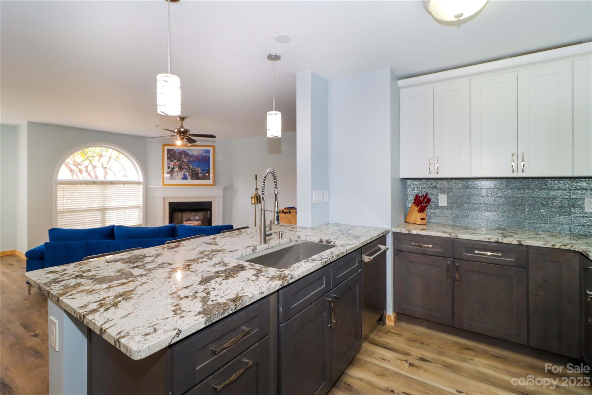 160 James Road, Unit 1D High Point, NC 27265 - Photo 16 of 33 a kitchen with kitchen island granite countertop wooden cabinets a sink and dishwasher