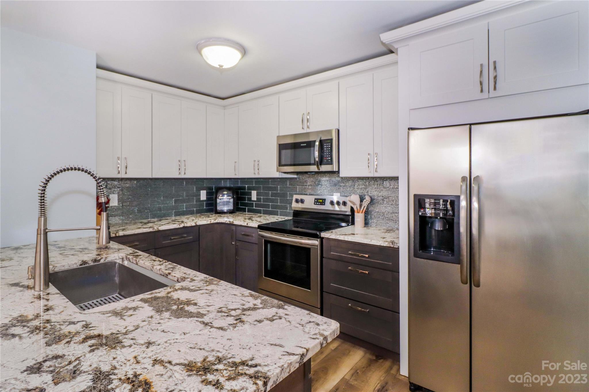 160 James Road, Unit 1D High Point, NC 27265 - Photo 17 of 33 a kitchen with a refrigerator sink and stainless steel appliances