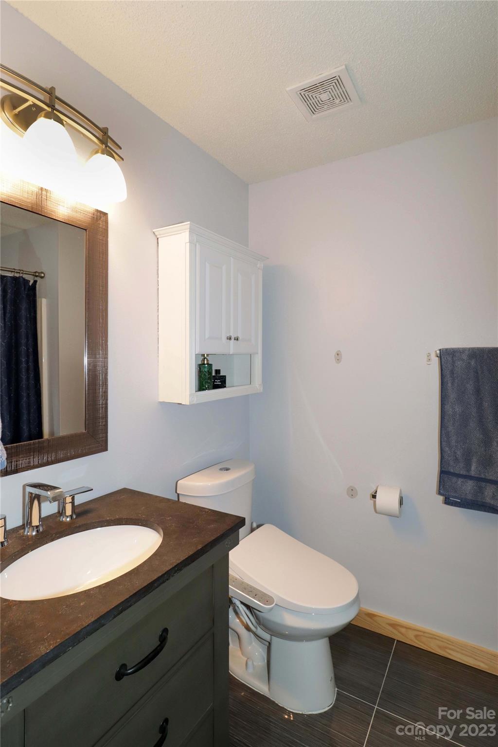 160 James Road, Unit 1D High Point, NC 27265 - Photo 22 of 33 a bathroom with a granite countertop toilet sink and mirror