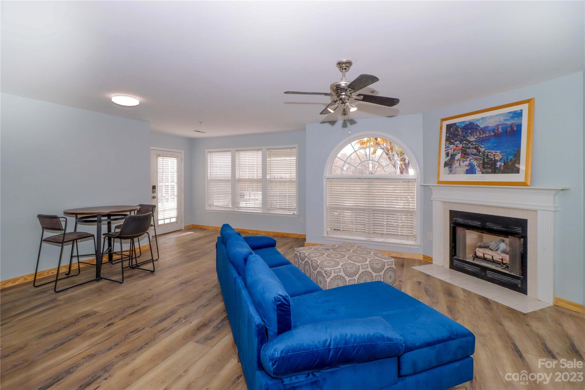 160 James Road, Unit 1D High Point, NC 27265 - Photo 4 of 33 a living room with furniture a fireplace and a chandelier