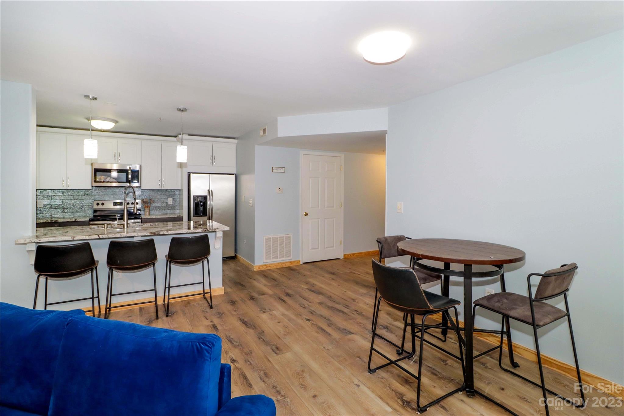 160 James Road, Unit 1D High Point, NC 27265 - Photo 8 of 33 a view of kitchen with furniture and wooden floor