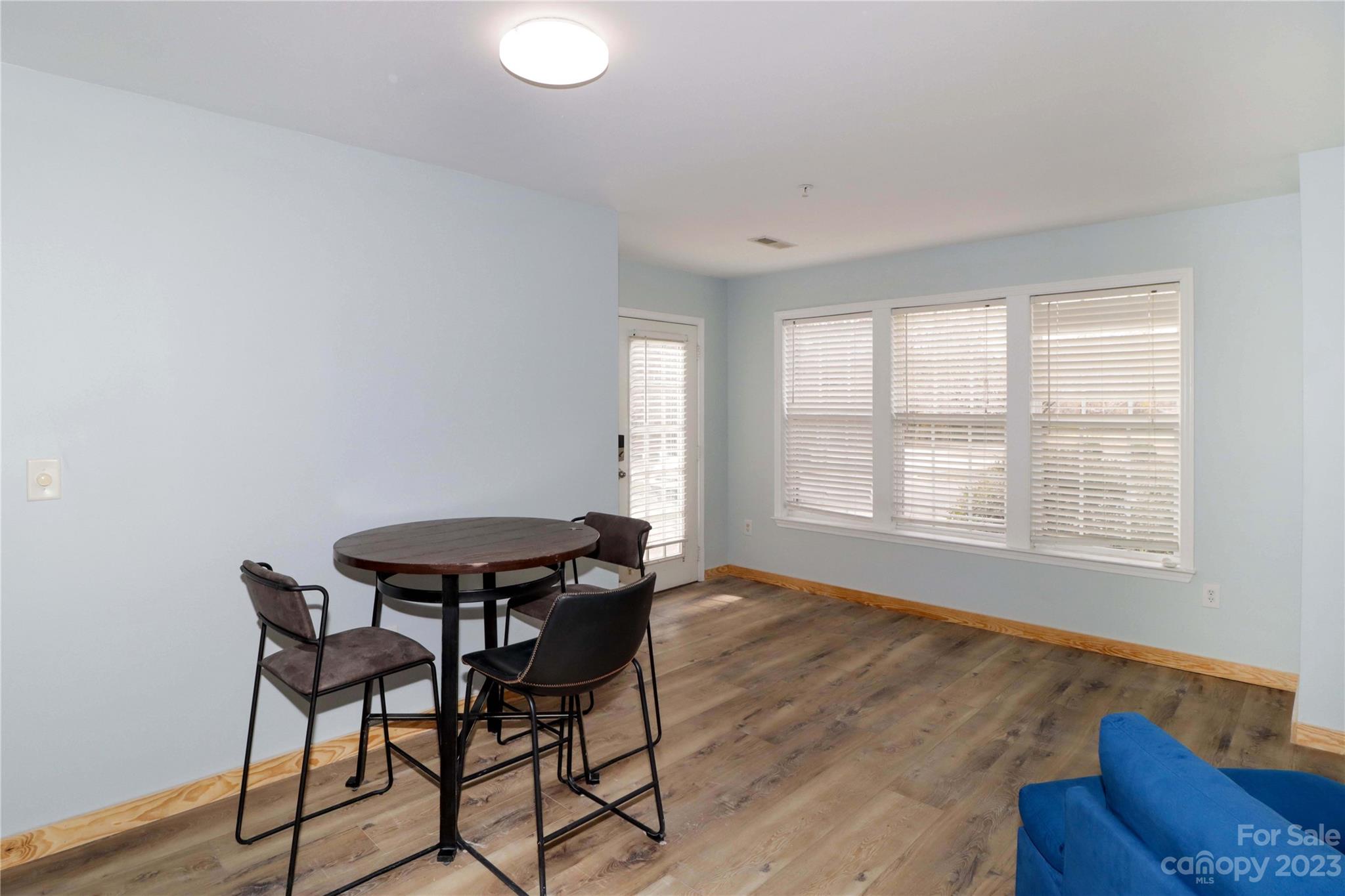 160 James Road, Unit 1D High Point, NC 27265 - Photo 9 of 33 a view of a dining room with furniture and wooden floor