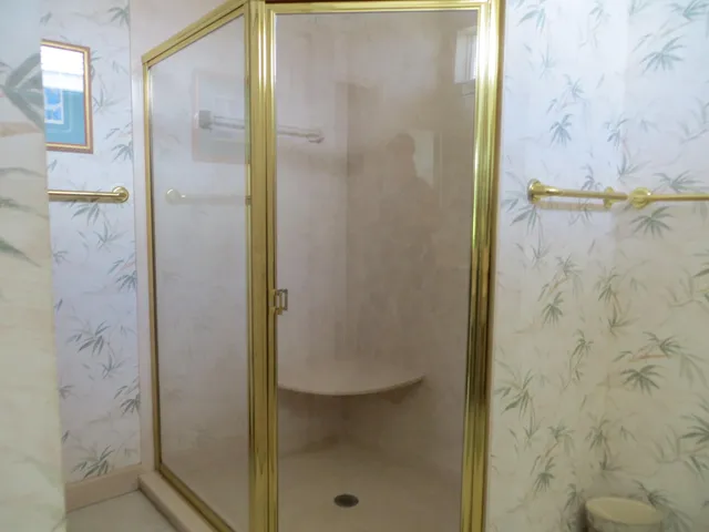 a bathroom with a glass shower door