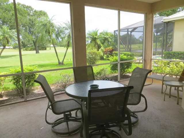 a view of an outdoor dining space with furniture and garden