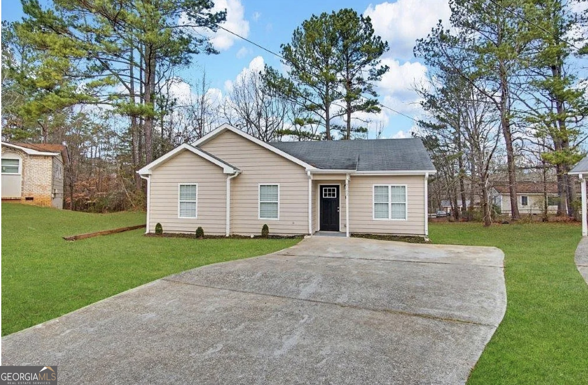 9102 Morris Drive Southwest Covington, GA 30014 - Photo 1 of 3 a front view of a house with a yard and trees