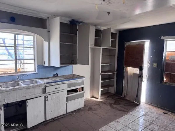 a kitchen with stainless steel appliances a refrigerator sink and cabinets