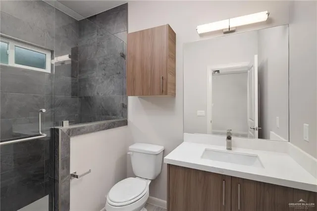 a bathroom with a sink toilet and shower