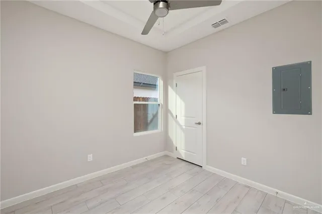 a view of a livingroom with wooden floor and a ceiling fan