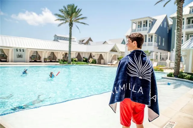 a view of a balcony with chairs and wooden floor