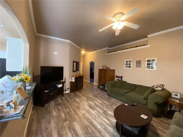 a living room with furniture and a flat screen tv