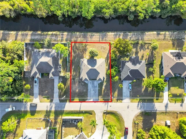 a view of swimming pool with outdoor seating and a garden