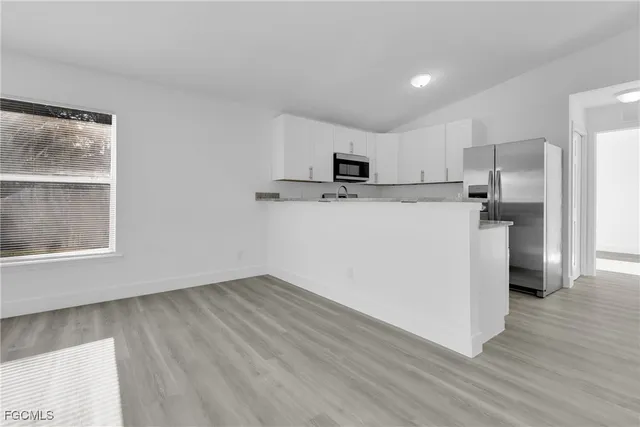 a kitchen with stainless steel appliances a refrigerator and a stove top oven