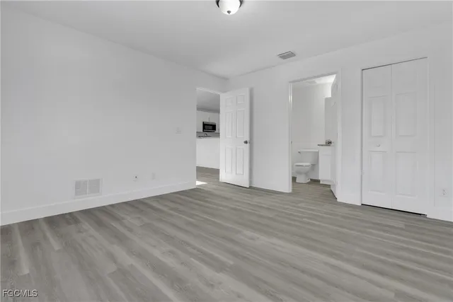 a view of an empty room and wooden floor