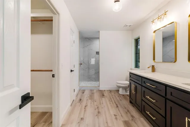 a spacious bathroom with a shower sink and a toilet