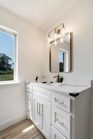 a bathroom with a double vanity sink and a mirror