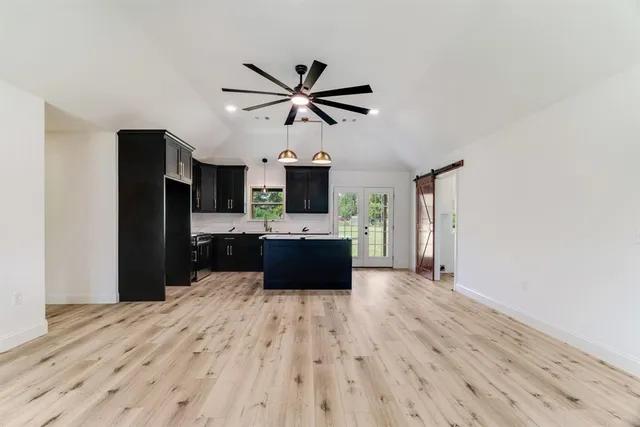 a kitchen with stainless steel appliances a sink and a refrigerator