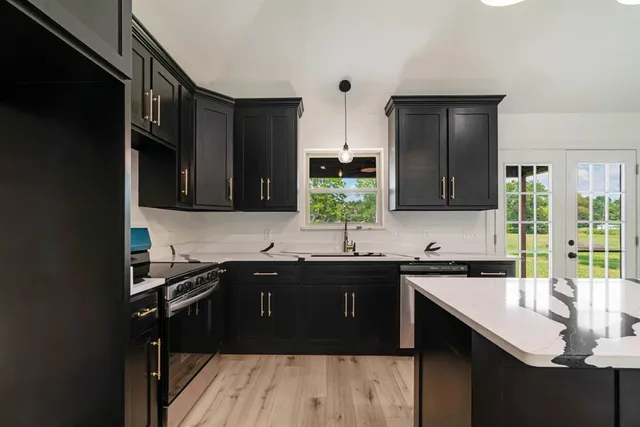 a kitchen with a sink and cabinets