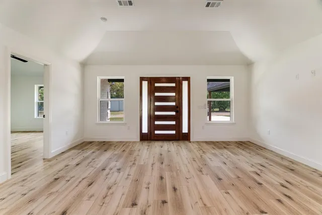 wooden floor in an empty room with a window