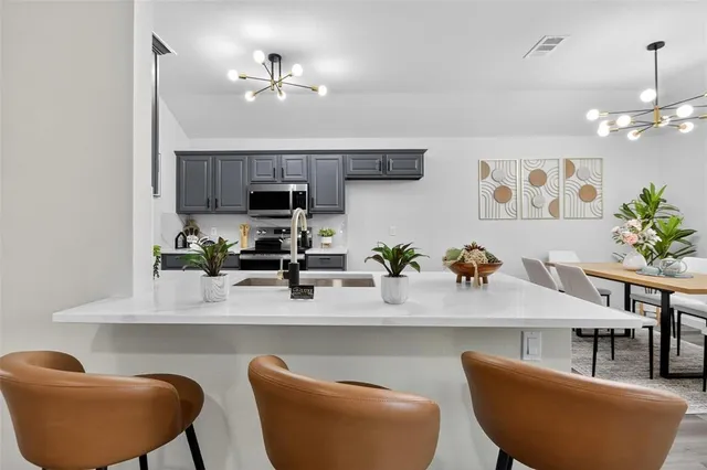 a dining room with furniture and a chandelier