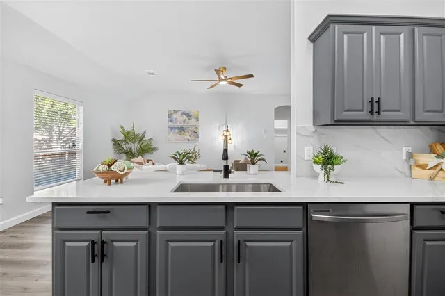 a kitchen with a sink and cabinets