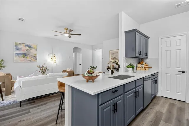 a bathroom with a sink double vanity granite tub and a mirror