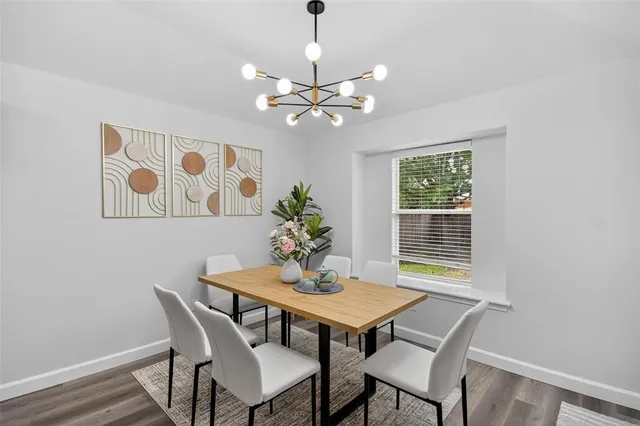 a view of a dining room with furniture window and wooden floor