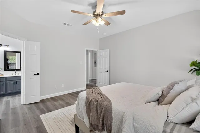 a bedroom with a bed chandelier and a window