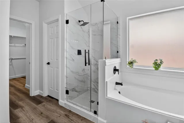 a bathroom with a bathtub and a shower