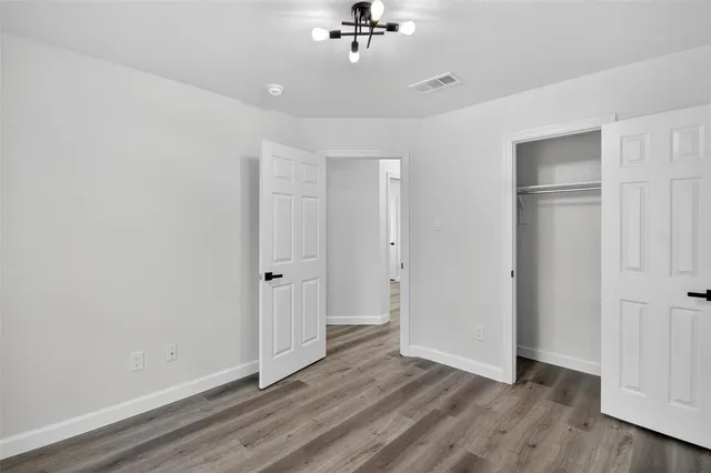 a view of a room with wooden floor