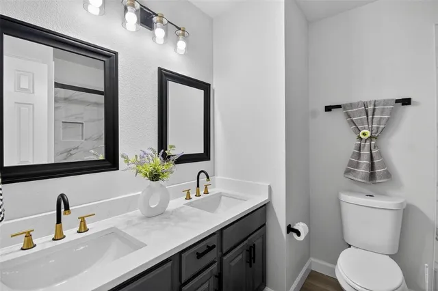a bathroom with a toilet sink and mirror