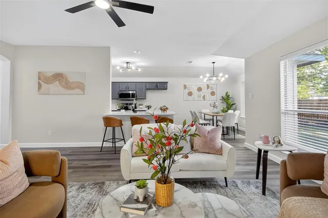 a living room with furniture and wooden floor
