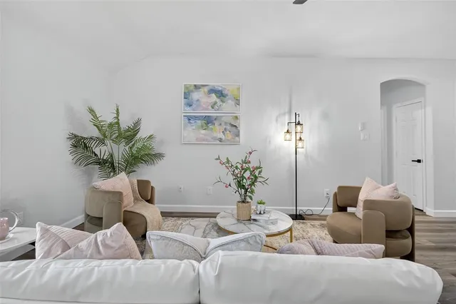 a living room with furniture potted plant and a window
