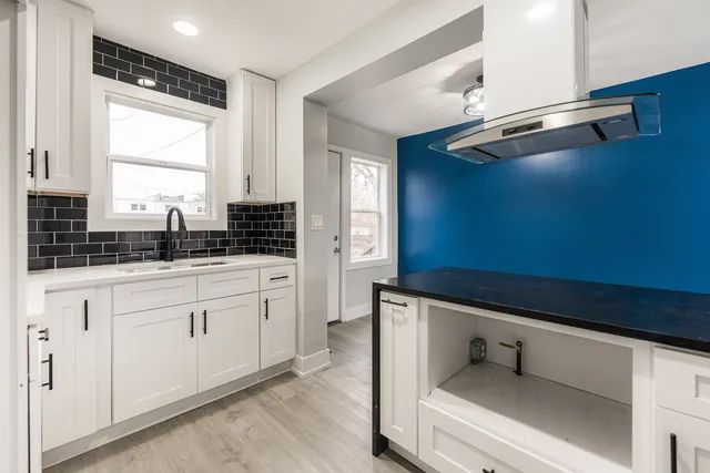 a kitchen with a sink cabinets and window