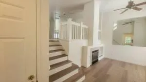 a view of a hallway with entryway wooden floor and front door