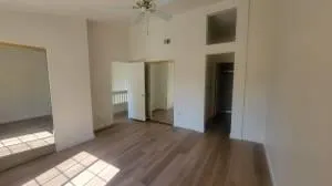 a view of a livingroom with an empty space and a window