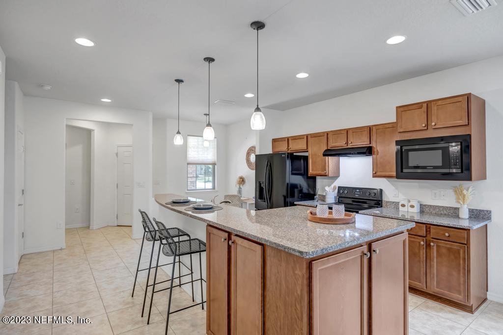 265 Caspia Lane Ponte Vedra, FL 32081 - Photo 13 of 86 a kitchen with stainless steel appliances granite countertop a sink stove and microwave