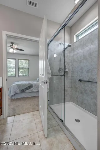 an empty room with a chandelier fan