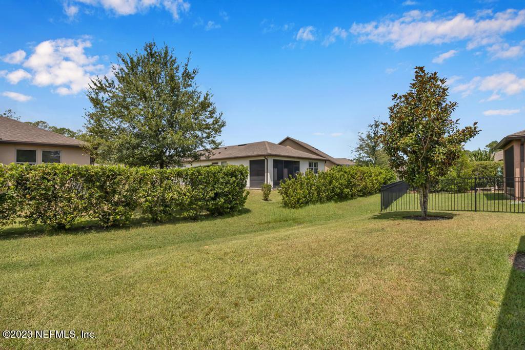265 Caspia Lane Ponte Vedra, FL 32081 - Photo 36 of 86 a yellow house with trees in front of it